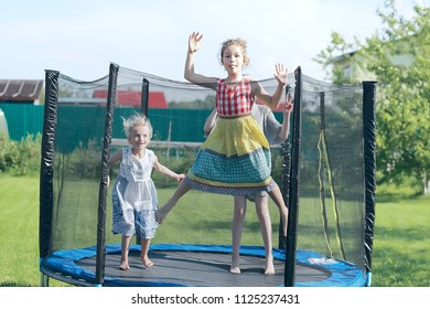 children jumping on a trampoline, girlfriends having fun in the summer in a recreation park on a trampoline - Shutterstock ID 1125237431