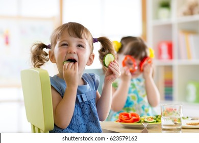 Children Kids Eating Vegetables In Kindergarten Or At Home