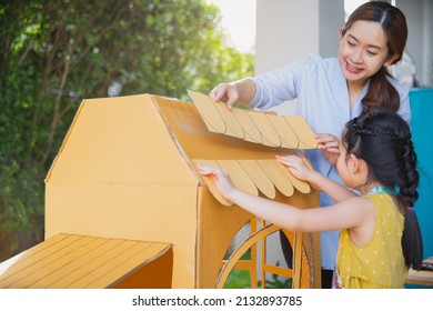 Children Kids Girls And Mother Hand Making  Paper House At Home. Asian Little Child Girl Make And Playing With Cardboard House With Her Mom.