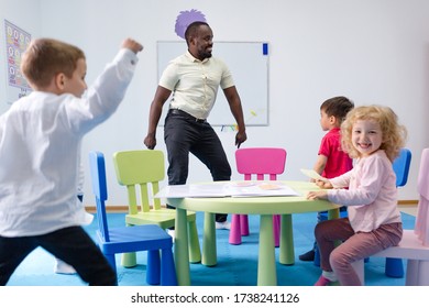 Children With A Kindergarten Teacher Dance In A Group