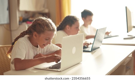 children learn from home through computers. business concept of modern training and development. group of little kids perform tasks in a lifestyle laptop at home schooling. educating from home - Powered by Shutterstock