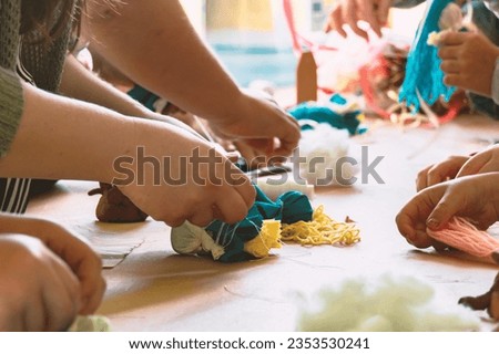Children learn how to make a rag doll.