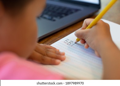 Children Learning How To Write The Alphabet, Pencil And Notebook. School Online. Handwriting.