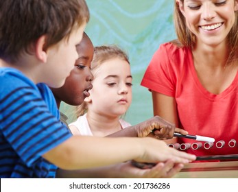 Children Learning Instruments In Music School In Musical Education Class
