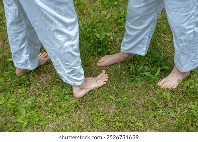 children learning life skills through martial arts, Two young judokas aged 10-12 in white kimonos hone their skills, throws and holds, judo training, goal-setting - Powered by Shutterstock