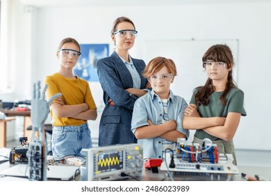 Children learning robotics in Elementary school. Young students building robot in after school robotics club. Field trip to real robotics laboratory.