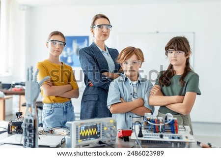 Children learning robotics in Elementary school. Young students building robot in after school robotics club. Field trip to real robotics laboratory.