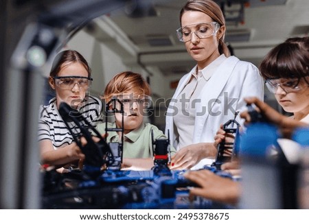 Children learning robotics in Elementary school. Young students building robot in after school robotics club.