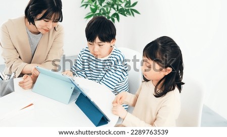 Children learning from a teacher with tablet PC.