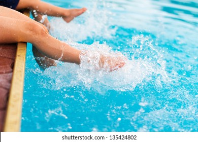 Children legs in the water splashing