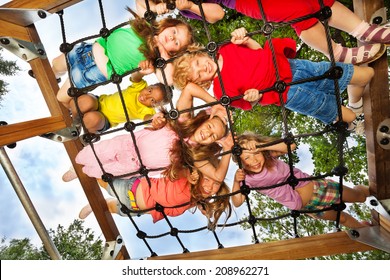 Children Look Though Gridlines Of Playground