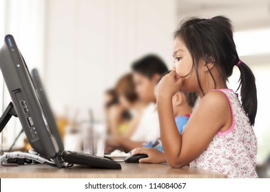 Children Looking Computer In Classroom