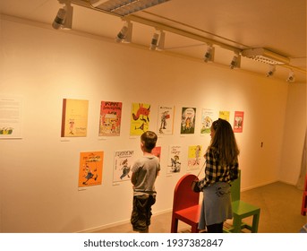 Children looking at different multilingual book covers of Pippi Longstocking books at Astrid Lindgren's World theme park, Vimmerby, Sweden. 