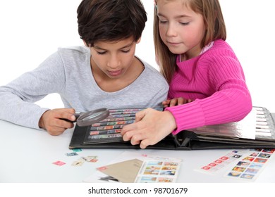 Children looking at a stamp album