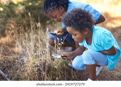 Children, magnifying glass and explore nature outdoor for education, vacation journey or wildlife discover. Siblings, grass park and forest for research on mountain field or adventure, holiday or fun - Powered by Shutterstock