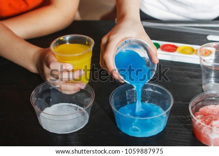 Children make experiments with paint and artificial snow