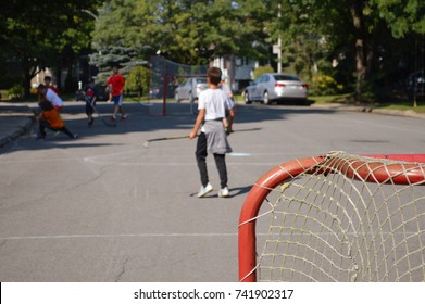 Children making sport and having fun in a street hockey game
