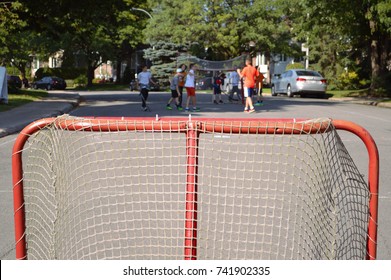 Children making sport and having fun in a street hockey game