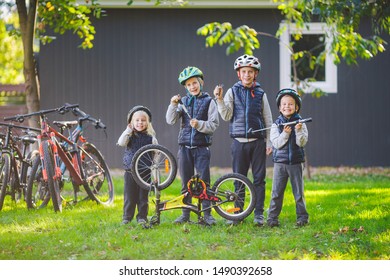 Children Mechanics, Bicycle Repair. Happy Kids Fixing Bike Together Outdoors In Sunny Day. Bicycle Repair Concept. Teamwork Family Posing With Tools For Repairing A Bicycle In Hands Outside.