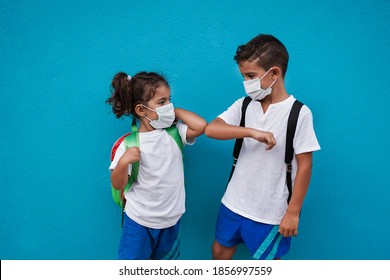 Children Meet And Greet Each Other With Elbows While Wearing Surgical Face Mask For Coronavirus