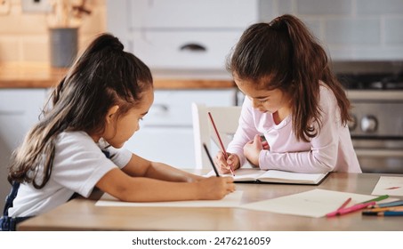 Children, notebook and learning in kitchen house with creative drawing, art and studying for education growth. Girls, artist and writing books, bonding and support for motor development at home - Powered by Shutterstock