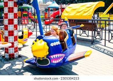 children on the airplane carousel attraction