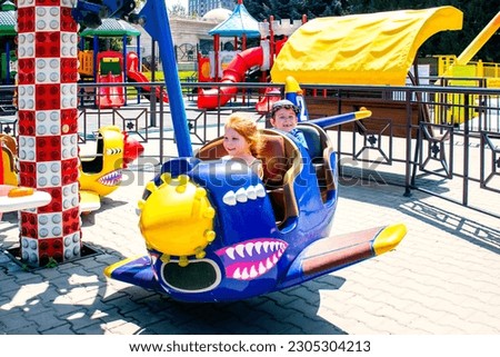 children on the airplane carousel attraction