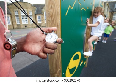 Children On Climbing Wall In School Physical Education Class