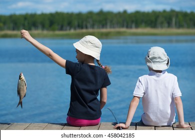 children on the dock with fish - Powered by Shutterstock