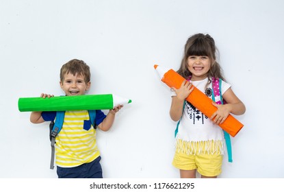Children on empty banner on which you can write any text. The concept of childhood and advertising of children's goods. Isolated on white background. Kids write with pencil on wall
