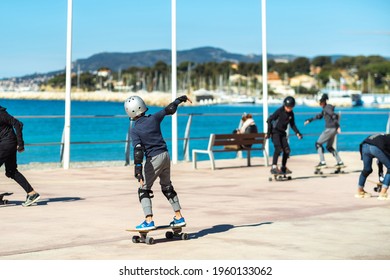 Children on skateboards on the embankment of the village of Saint-Cyr-sur-mer, France. - Powered by Shutterstock