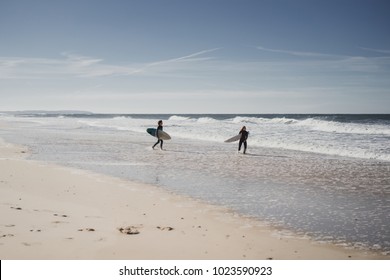 Children On Surfing. Nazare, Portugal. Children And Teenagers In Wetsuits Surf Boards.