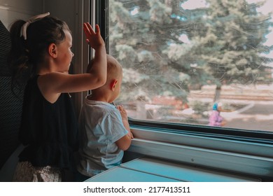 Children On The Train Wave Goodbye Through The Window.