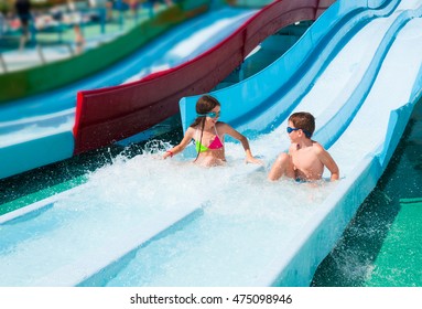 Children On Water Slide In Aqua Park