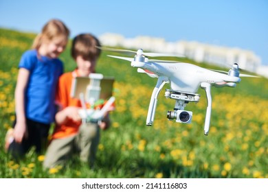 Children Operating Of Flying Drone At Field