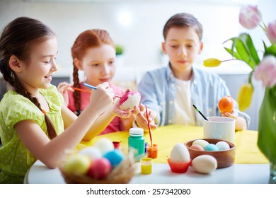 Children Painting Eggs At School