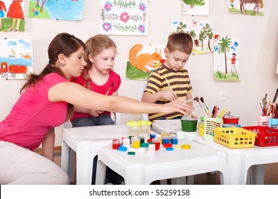Children painting with teacher in art class. Child care. - Shutterstock ID 55259158