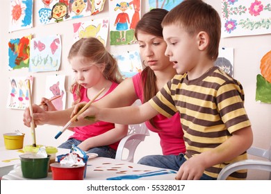 Children Painting With Teacher In Art Class. Child Care.