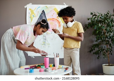 Children Painting Together With Paints