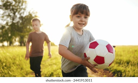 children in the park. play ball, run and team up. happy family kid a dream concept. children run, play ball and learn to teamwork. children run, play ball and spend time in the park lifestyle - Powered by Shutterstock