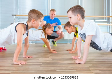 Children At Physical Education Lesson In School Gym Gymnast Kid