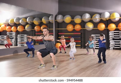 Children At Physical Education Lesson In School Gym