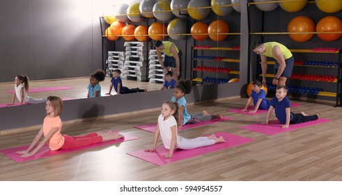 Children At Physical Education Lesson In School Gym