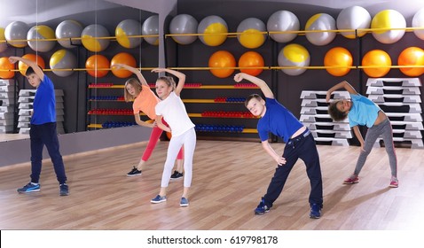 Children At Physical Education Lesson In School Gym