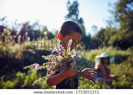 Similar – Image, Stock Photo little boy picks flowers in the garden