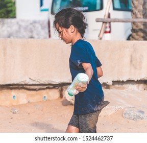 Children Is Picking Up Plastic Bottle And Gabbage That They Found On The Beach For Enviromental Clean Up Concept