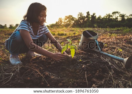 children planting tree in garden. concept eco earth day