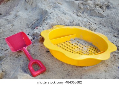 Children Plastic Strainer And Shovel In Sandpit