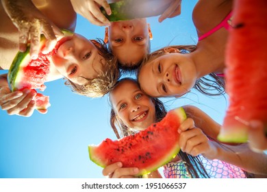 Children play by the sea and eat watermelon. High quality photo. - Powered by Shutterstock