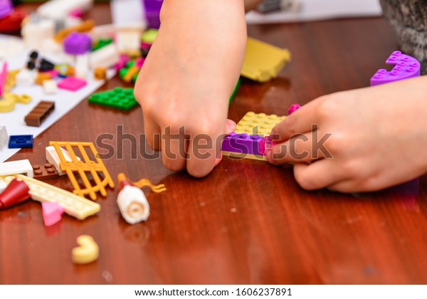 Children play in a children\'s designer and build\
different figures from\
it.